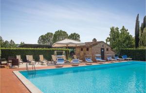 a swimming pool with chairs and an umbrella at Casa Girasole in Panicarola