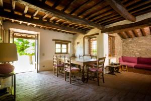 a living room with a table and chairs and a couch at Agriturismo fringuello - Sofora in Cortona