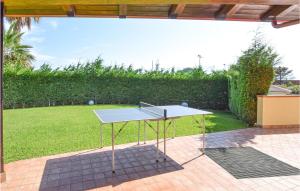 a ping pong table in the middle of a yard at Stunning Home In Sangineto Lido in Belvedere Marittimo