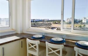 a kitchen with a table and chairs and windows at Beautiful Apartment In Sucina With Wifi in Sucina