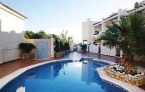 basen z palmą obok budynku w obiekcie Cozy Home In Nerja With Wifi w mieście Nerja +16 zdjęć