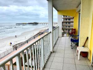 a balcony with a view of the beach and pier at Sand Castle Motel in Daytona Beach Shores