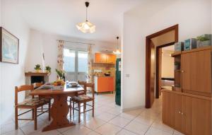 a kitchen and dining room with a table and chairs at Casa Sole Rosso in Buggerru