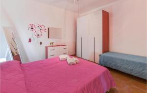 ein Schlafzimmer mit einem rosa Bett und einer Kommode in der Unterkunft La Casa Sul Mare in Trappeto