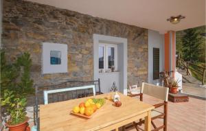 a dining room with a wooden table with fruit on it at Cataverna in Montedivalli Chiesa