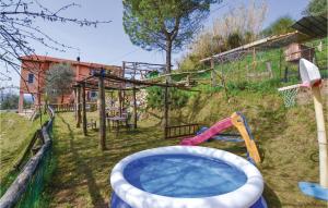 a backyard with a pool and a playground at Cataverna in Montedivalli Chiesa