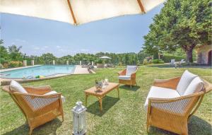 a yard with chairs and a table and a pool at Villa Agata in Latera
