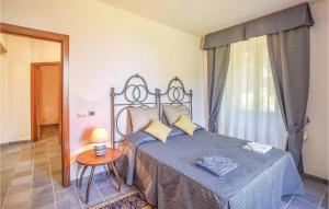 a bedroom with a bed and a table and a window at Villa Agata in Latera