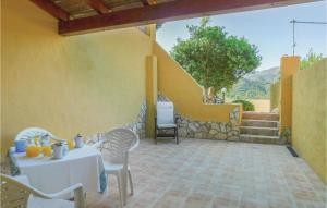a patio with a table and chairs and a staircase at Nice Apartment In Gonnesa With Wifi in Gonnesa +6 photos