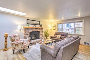 a living room with two couches and a fireplace at Port Angeles Abode with Yard and Guest House! in Port Angeles
