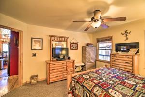 a bedroom with a bed and a flat screen tv at 'River Dream Cabin' on New River w/ Fire Pit in Piney Creek