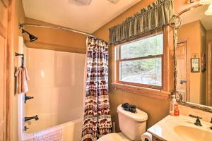 a bathroom with a toilet and a sink and a window at 'River Dream Cabin' on New River w/ Fire Pit in Piney Creek +34 photos