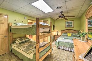 a bedroom with two bunk beds and a ceiling fan at 'River Dream Cabin' on New River w/ Fire Pit in Piney Creek