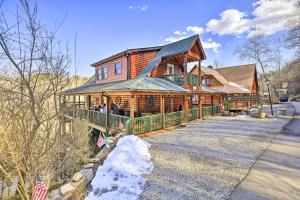 a large wooden house with snow on the ground at 'River Dream Cabin' on New River w/ Fire Pit in Piney Creek