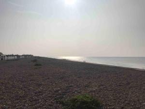 a beach with the ocean in the background at Goring Beach Studio - 2 min walk from seafront in Goring by Sea