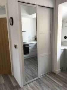 a kitchen with a sliding glass door in a room at Goring Beach Studio - 2 min walk from seafront in Goring by Sea