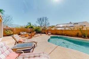 a patio with chairs and a swimming pool at Bedrock Lane in Oro Valley