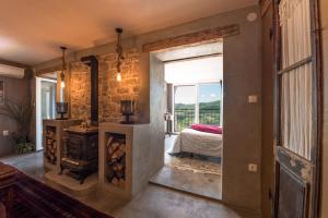 a room with a fireplace and a bed and a window at Birdhouse in Motovun