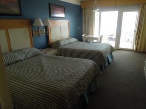 a hotel room with two beds and a window at Royal Atlantic Beach Resort in Montauk