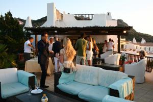 a group of people standing on a patio at Hotel Luci di la Muntagna in Porto Cervo
