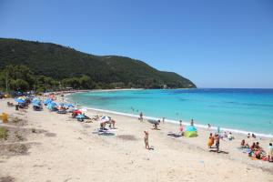 a group of people on a beach with the ocean at Kydonies Villas in Lefkada