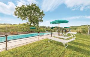 a pool with two lounge chairs and an umbrella at Ginestre 3 in Mengara