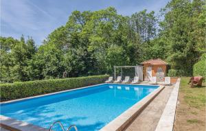 a swimming pool with chairs and a gazebo at Villa Castelli Romani in Genzano di Roma