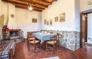 a dining room with a table and a fireplace at Amazing Home In Raccuja With 4 Bedrooms And Wifi in Raccuia