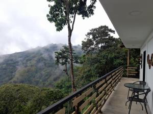 a balcony with a view of a mountain at Entre Verdes Hotel & Glamping in Medellín