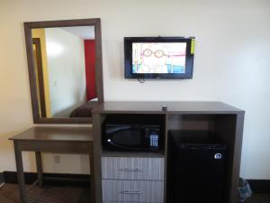 a room with a microwave and a mirror at Brick Motor Inn in Brick