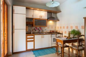 a kitchen with a white refrigerator and a table at Villa Raniero Gatti in San Michele in Teverina