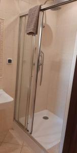 a shower with a glass door in a bathroom at Restauracja Hotel 4u in Kańczuga
