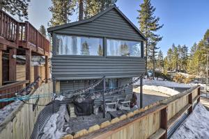 a tiny house on a deck with a porch at Cozy Zephyr Cove Cabin, Walk to Lake Tahoe! in Zephyr Cove