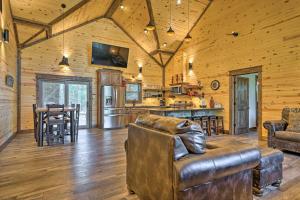 a living room with a couch and a kitchen at Ouachita Mtn Home Near ATV and Hiking Trails! in Big Cedar