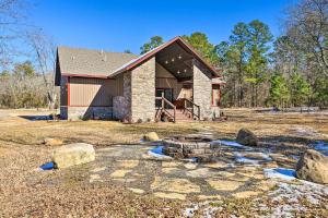 a home with a fire pit in the yard at Ouachita Mtn Home Near ATV and Hiking Trails! in Big Cedar