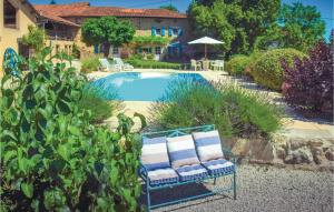 a swimming pool with two chairs in a yard at Awesome Home In Suaux With 6 Bedrooms, Wifi And Private Swimming Pool in Chichiat