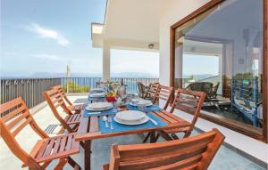 a dining room with a table and chairs on a balcony at Villa Belvedere in Castellammare del Golfo