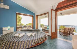 a bedroom with a large bed and a balcony at Villa Belvedere in Castellammare del Golfo