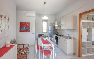 a kitchen and dining room with a table and chairs at Casa Lilla in Porto Palo +6 photos