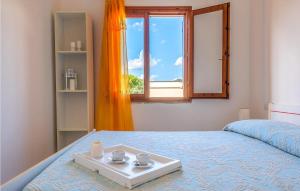 a bedroom with a bed with a tray on it at Trilo 6 in San Teodoro