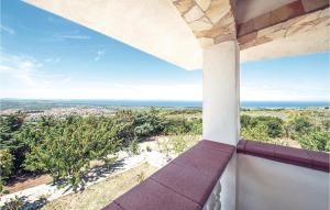 a view of the ocean from the balcony of a house at Villa Anna in Sennori