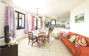 a living room with a couch and a table at Villa Anna in Sennori