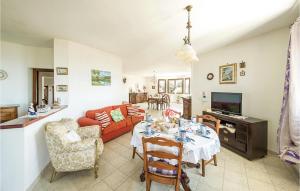a living room with a table and a couch at Villa Anna in Sennori +12 photos