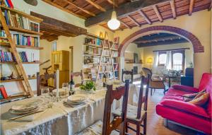 a living room with a table and a red couch at Nice Home In Greve In Chianti With 3 Bedrooms And Wifi in Greve in Chianti