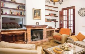 a living room with a fireplace and a tv at Awesome Home In Arcos De La Frontera With 7 Bedrooms, Wifi And Outdoor Swimming Pool in Arcos de la Frontera