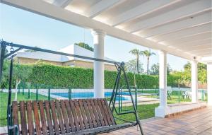 a porch swing with a view of a swimming pool at Awesome Home In Arcos De La Frontera With 7 Bedrooms, Wifi And Outdoor Swimming Pool in Arcos de la Frontera