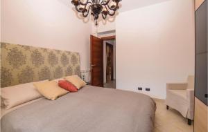 a bedroom with a bed and a chandelier at Casa Virgilio in Viareggio