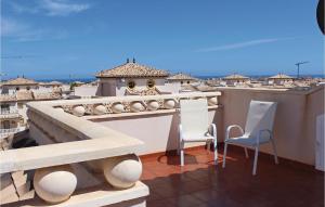 a balcony with a counter and chairs on a roof at 2 Bedroom Lovely Home In Orihuela Costa in Orihuela Costa