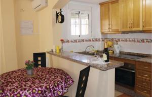 a kitchen with a counter and a table and a sink at 2 Bedroom Lovely Home In Orihuela Costa in Orihuela Costa