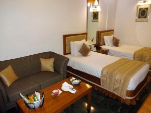 Postel nebo postele na pokoji v ubytování Regency Madurai by GRT Hotels